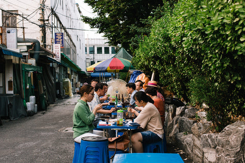 Customers sit on plastic tables outside Gyeongsangdo-jip, a nopo barbecue restaurant in the Dongdaemun district of Seoul, South Korea