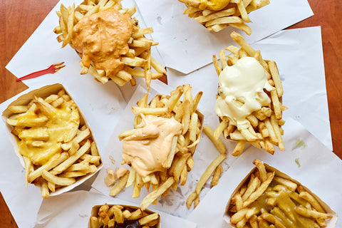 Belgian french fries from a fry shack (frietkot) topped with various kinds of mayonnaise and sauces in Antwerp, Belgium