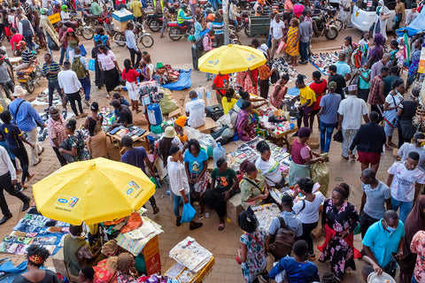 Crowds of people at an outdoor street market in Kampala, Uganda