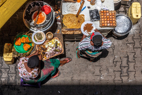 Women prepare food at a woteli in Kampala, Uganda