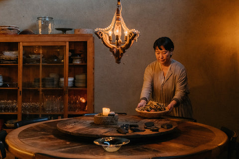 Chef and artist Masayo Funakoshi sets the table at her restaurant Farmoon in Kyoto, Japan