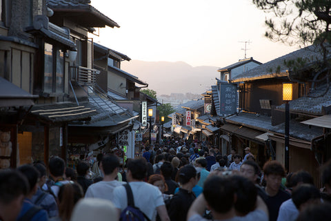 A crowded street in Kyoto, Japan at sunset