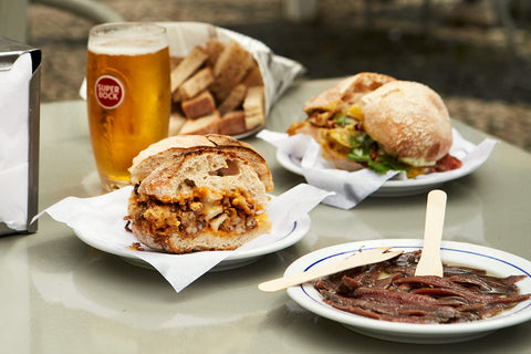 Plates of sandwiches and a glass of beer at Quiosque de São Paulo in Lisbon, Portugal