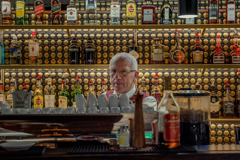 A waiter stands behind the bar at Galeto, an American-style diner in Lisbon, Portugal