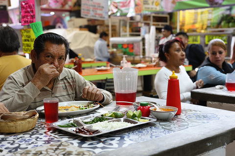 A man eats his lunch at a table in a fonda in Mexico City (CDMX), Mexico