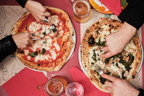 Two plates of traditional Neapolitan pizzas in Naples, Italy