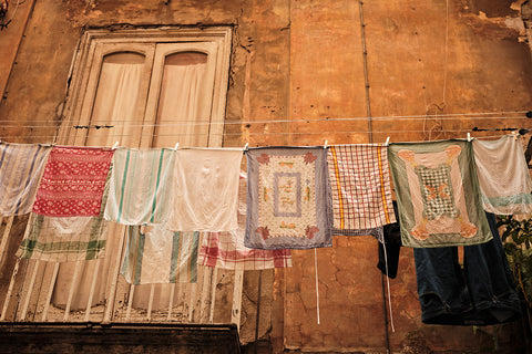 A laundry line of colourful tea towels in the streets of Naples, Italy