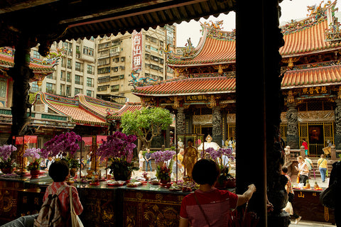 Locals leave offerings and prayers at a traditional temple in Taipei, Taiwan