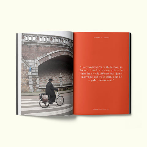 An interior spread of Fare magazine's Antwerp, Belgium city guide, featuring a photograph of a man in a hat riding a bicycle down the street