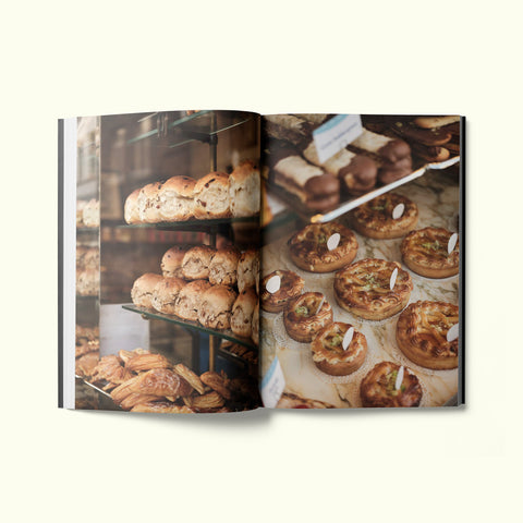 An interior spread of Fare magazine's Antwerp, Belgium city guide, featuring photographs of breakfast pastries at Bakkerij Goossens