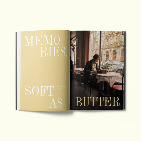 An interior spread of Fare magazine's Budapest, Hungary city guide, featuring a photograph by Liz Seabrook of a man reading a newspaper in Bambi Eszpresszó café