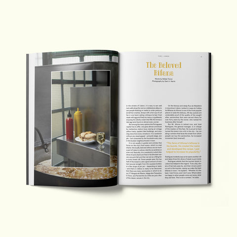 An interior spread of Fare magazine's Lisbon, Portugal city guide, featuring a photograph by Sam A. Harris of a bifana sandwich