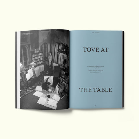An interior spread of Fare magazine's Helsinki city guide, featuring an archival black and white photograph of Tove Jansson painting in her studio in Finland