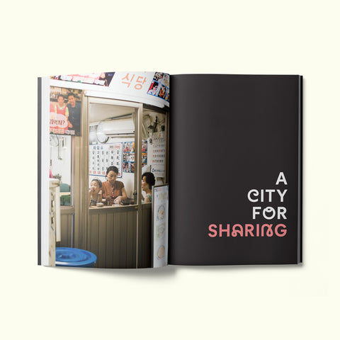 An interior spread of Fare magazine's Seoul, South Korea city guide, featuring a photograph of a family sharing a meal in a restaurant