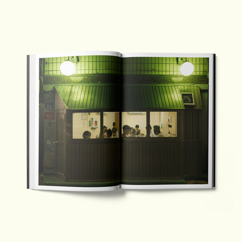 An interior spread of Fare magazine's Seoul, South Korea city guide, featuring a photograph looking in the window of a restaurant at night