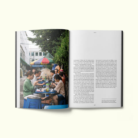 An interior spread of Fare magazine's Seoul, South Korea city guide, featuring a photograph of customers sitting at plastic tables outside of Gyeongsangdo-jip nopo barbecue restaurant